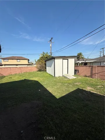 a view of yard with swimming pool and green space