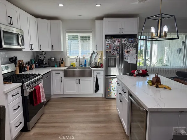 a kitchen with stove cabinets and wooden floor