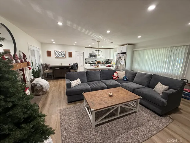 a living room with furniture a rug and a flat screen tv