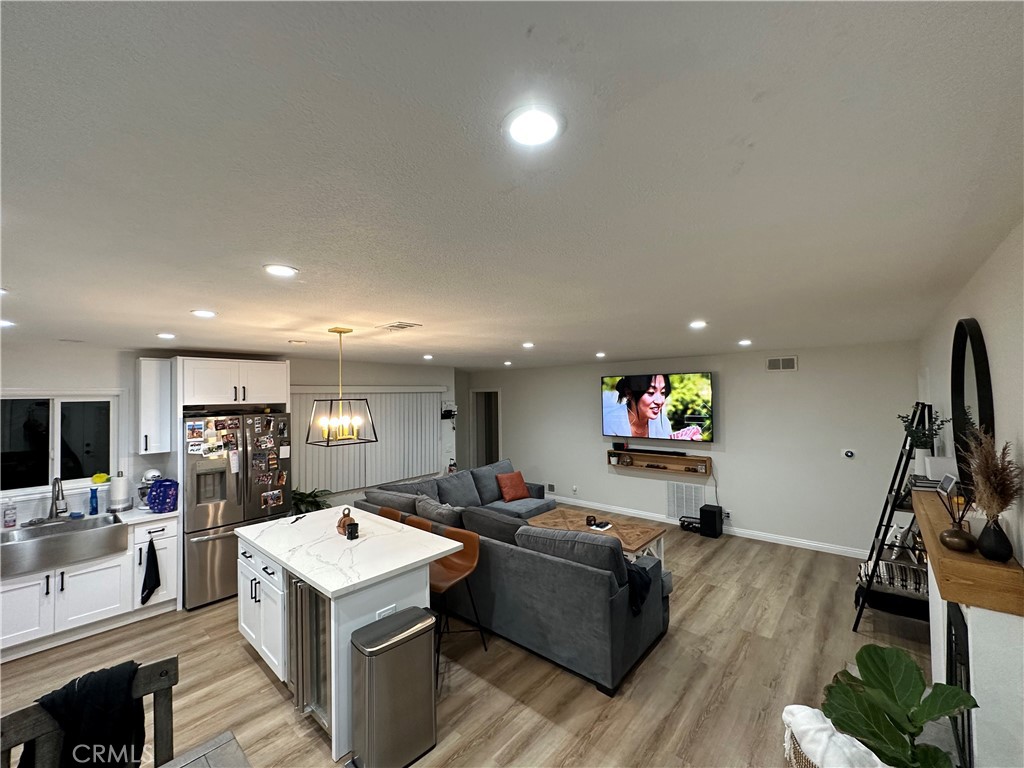 12042 Hackamore Road Garden Grove, CA 92840 - Photo 5 of 20 a living room with furniture a flat screen tv and a refrigerator