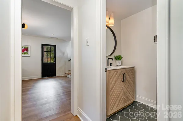 a view of a hallway with wooden floor and entryway