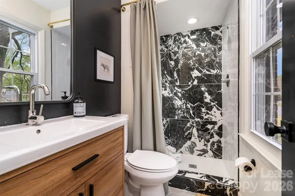 a bathroom with a sink toilet and shower