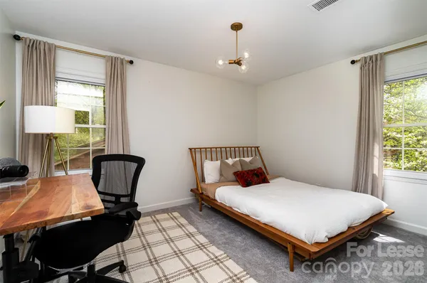 a bedroom with a bed and chair