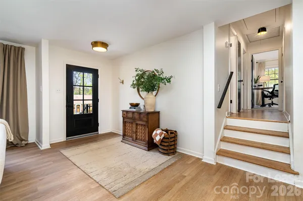 a view of a livingroom with furniture and staircase