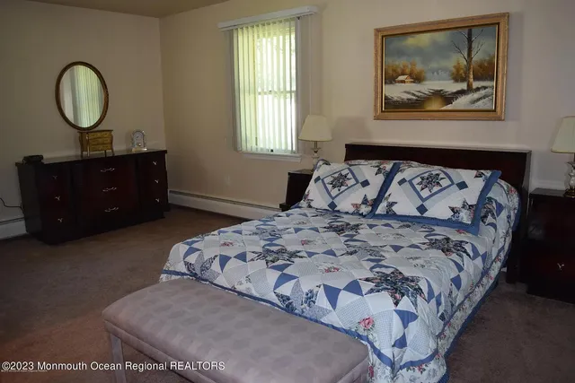 a bedroom with a bed and a painting on the wall