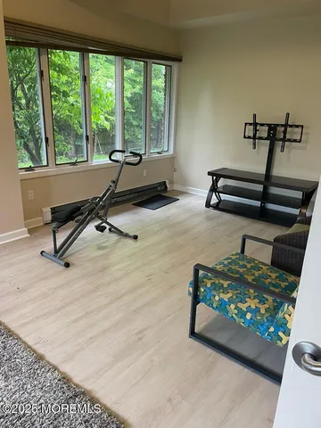 a view of a room with gym equipment and floor to ceiling window