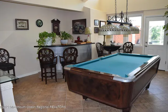 a room with furniture a chandelier and a table