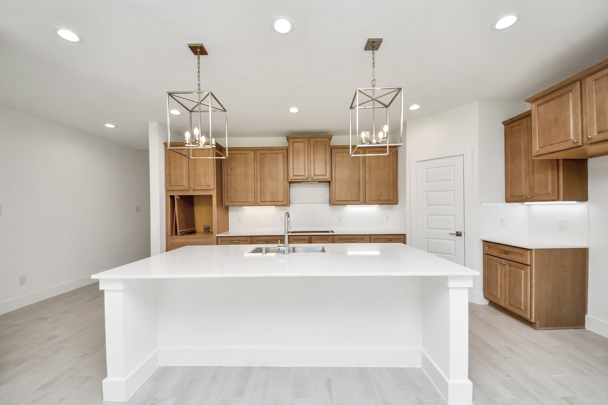 3102 Native Spg Drive Spring, TX 77373 - Photo 9 of 47 This kitchen is by far any chef’s dream! This spacious kitchen features high ceilings, stained wood cabinets, granite countertop, SS appliances, modern tile backsplash, recessed lighting, extended counter space, granite kitchen island with double sink, and space for breakfast bar, and a walk-in pantry all overlooking your huge family room.