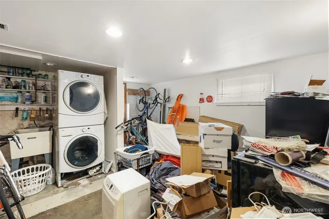 a view of a storage & utility room with sink dryer and washer