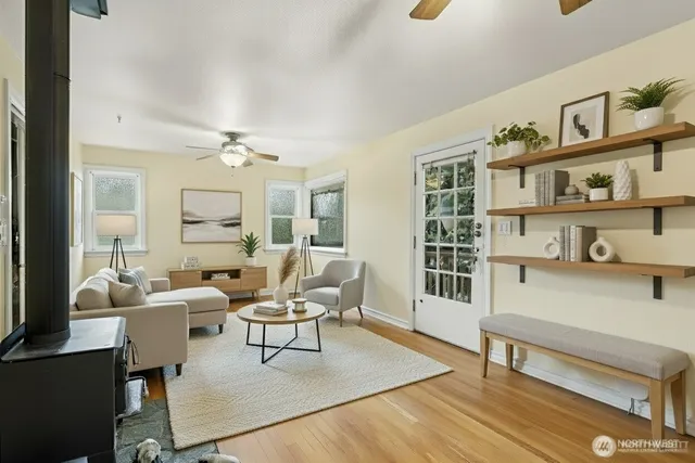 a living room with furniture and a wooden floor