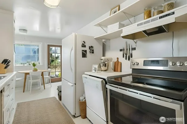 a kitchen with appliances and cabinets