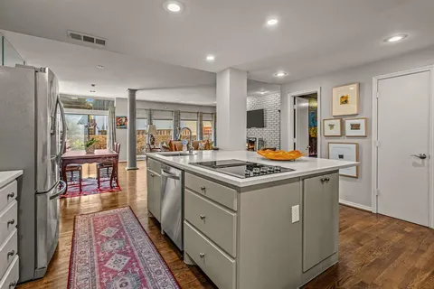 a kitchen with stainless steel appliances granite countertop a stove and a refrigerator