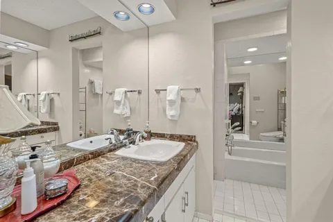 a bathroom with a granite countertop sink mirror and double