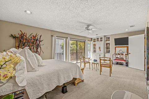 a bedroom with furniture and a large window