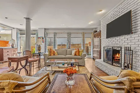 a living room with furniture fireplace and flat screen tv