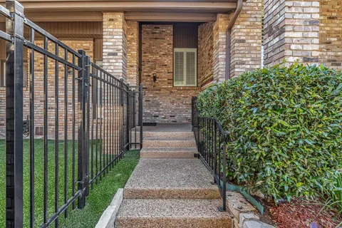a view of a pathway that has potted plants