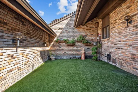 a view of a swimming pool with a yard and sitting space
