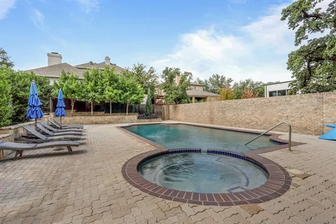 a view of a swimming pool with a patio