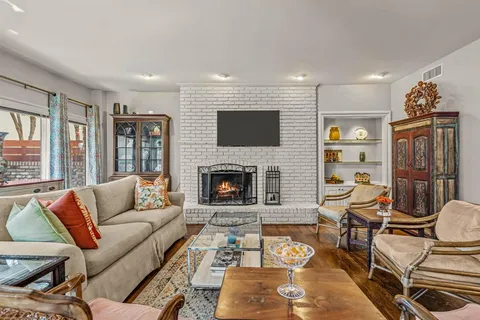 a living room with furniture fireplace and flat screen tv