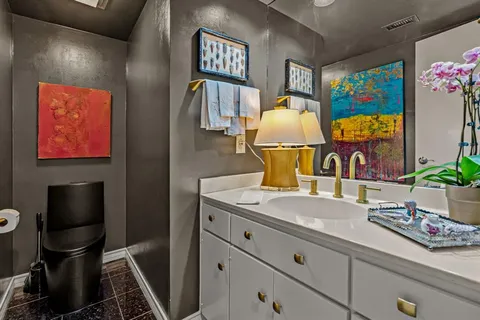 a bathroom with a sink mirror and vanity
