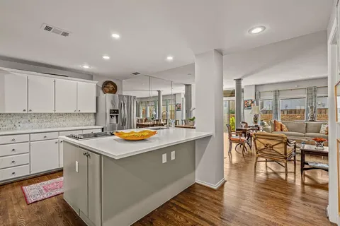 a kitchen with wooden cabinets and center island