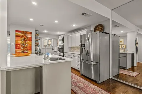 a kitchen with stainless steel appliances granite countertop a refrigerator and a sink