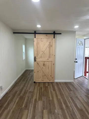 a view of a closet with wooden floor