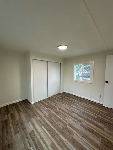 a open kitchen with kitchen island white cabinets and stainless steel appliances