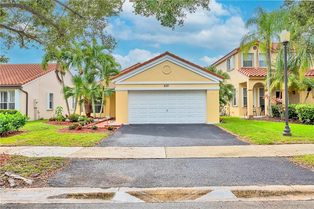 833 Falling Water Road Weston, FL 33326 - Photo 1 of 32 a front view of a house with a yard and garage