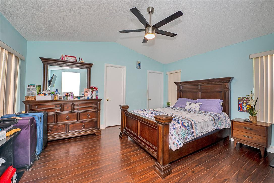 833 Falling Water Road Weston, FL 33326 - Photo 11 of 32 a bedroom with a bed and a large window