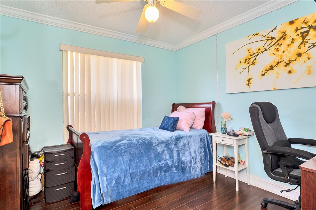 833 Falling Water Road Weston, FL 33326 - Photo 15 of 32 a bedroom with a bed and wooden floor