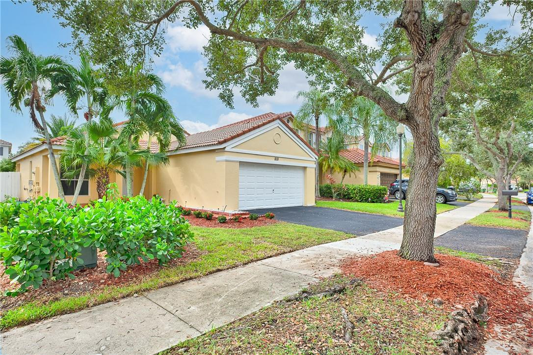 833 Falling Water Road Weston, FL 33326 - Photo 3 of 32 a front view of a house with garden