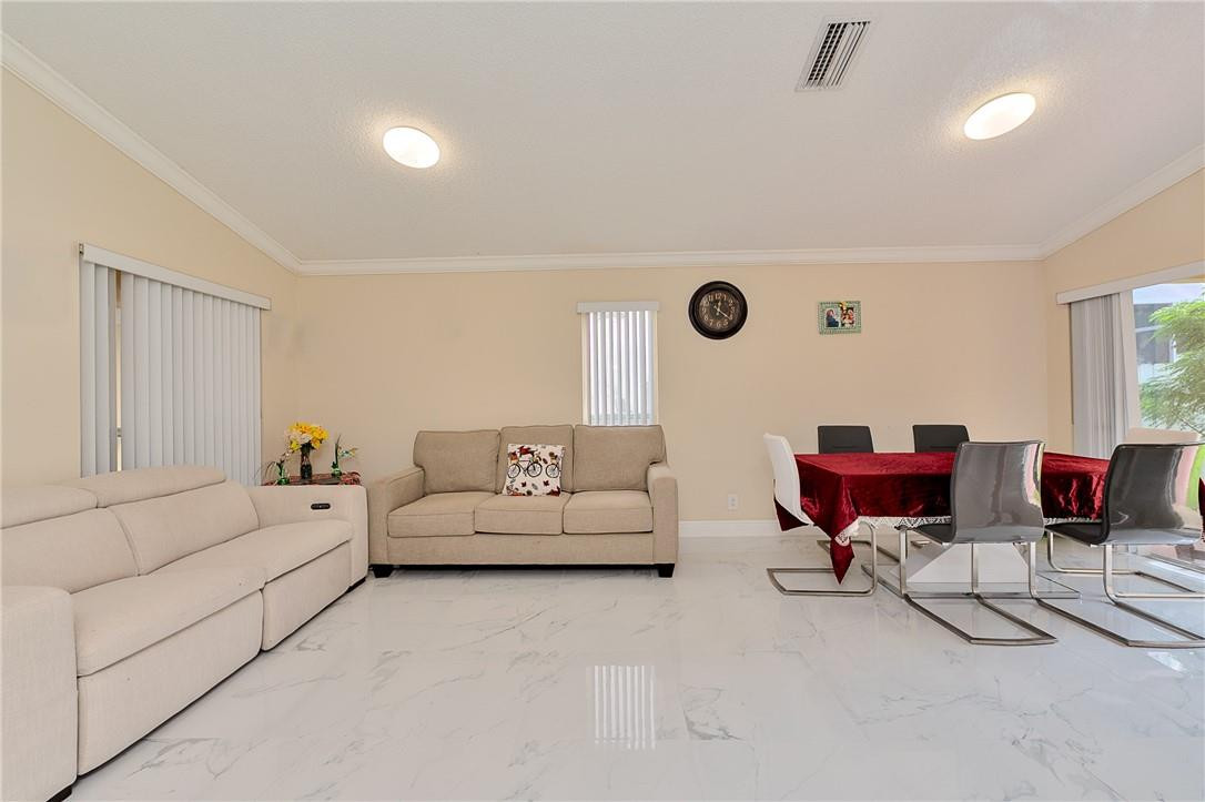 833 Falling Water Road Weston, FL 33326 - Photo 6 of 32 a living room with furniture and a rug