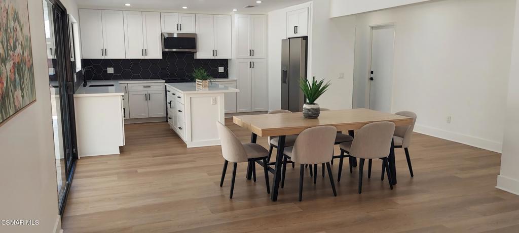 3477 Vicki Court Simi Valley, CA 93063 - Photo 4 of 23 a kitchen with a table chairs refrigerator and microwave