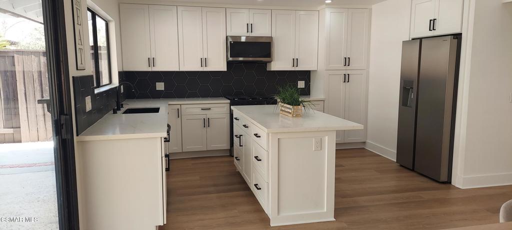 3477 Vicki Court Simi Valley, CA 93063 - Photo 6 of 23 a kitchen with a refrigerator sink and cabinets