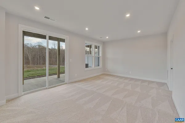 a view of an empty room with glass door