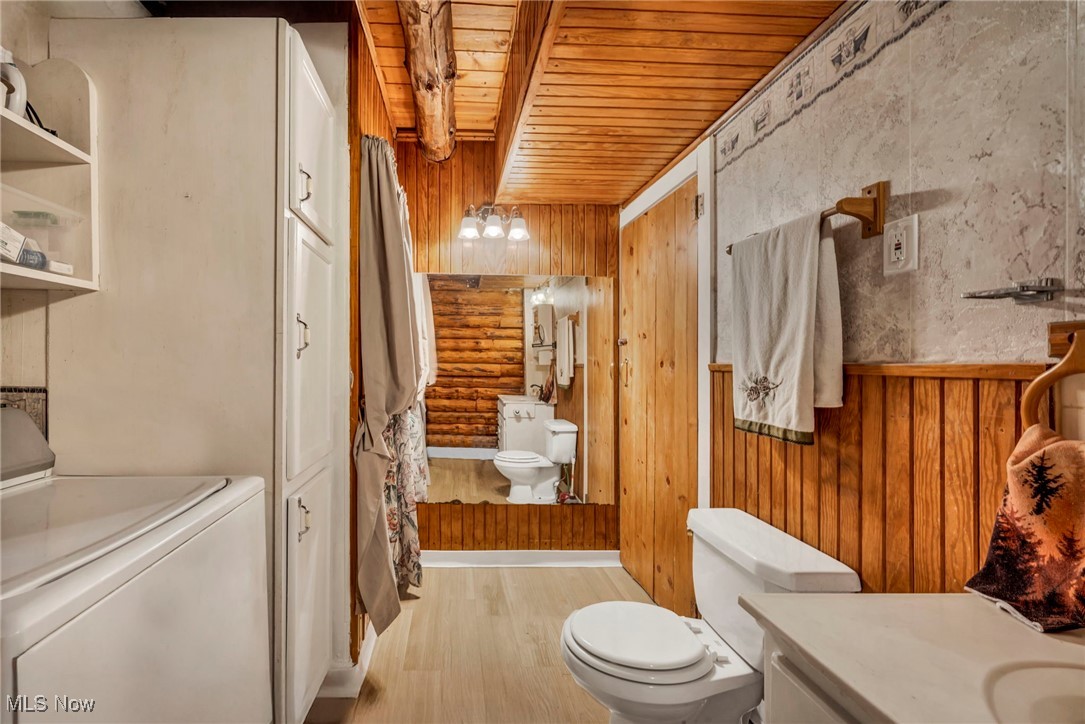 24455 Tryon Road Oakwood, OH 44146 - Photo 30 of 40 Full bathroom with wood finished floors, vanity, washer / dryer, wooden ceiling, and toilet