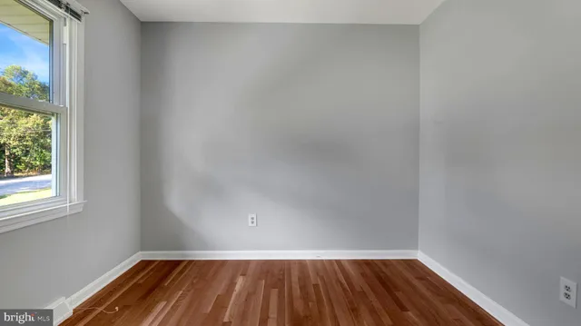 a view of room with window and hardwood floor