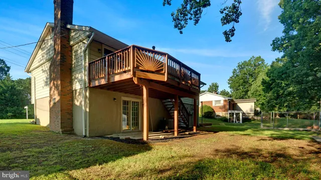 a view of a house with backyard porch and sitting area