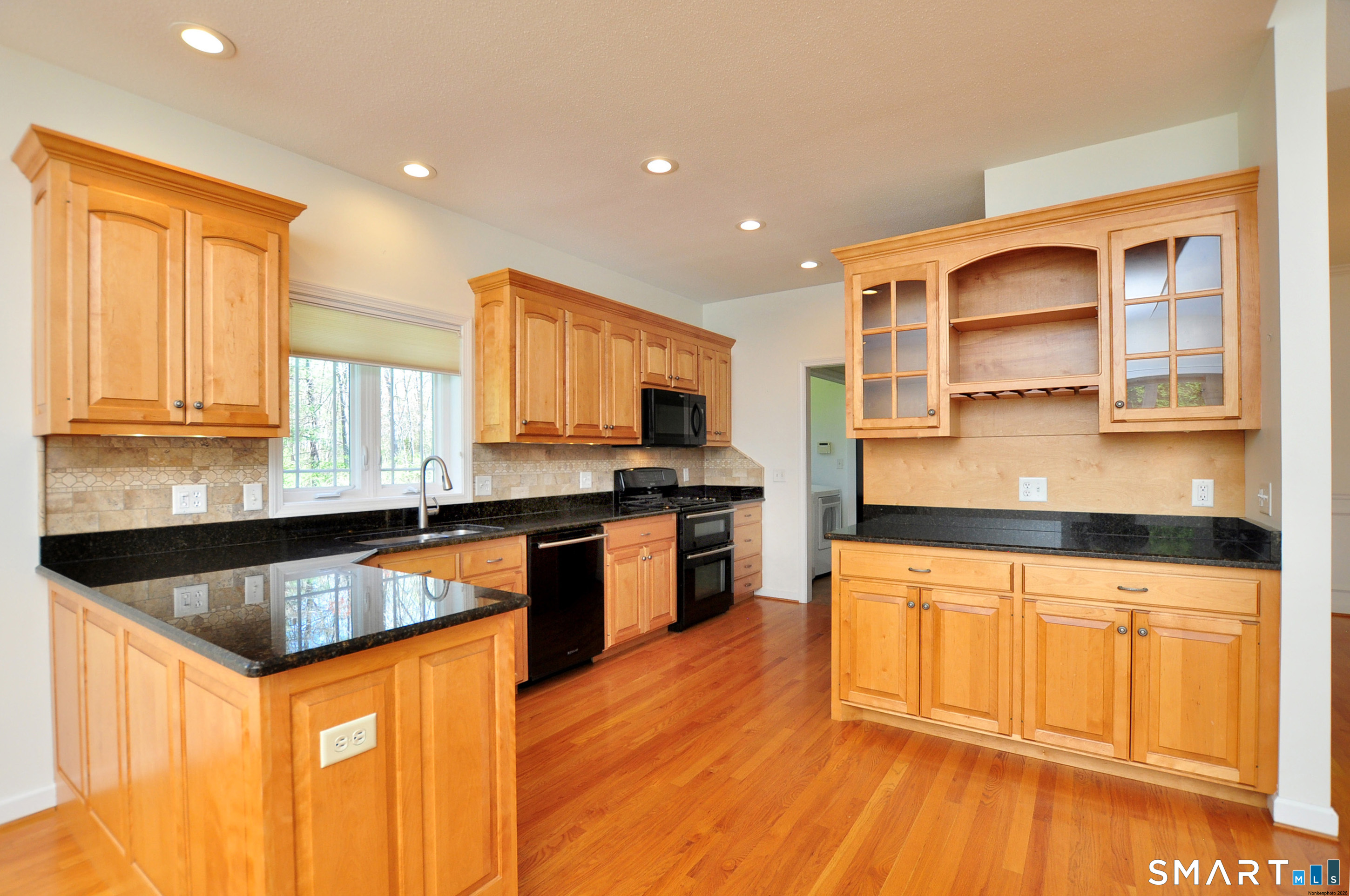 453 Tributary Lane Windsor, CT 06095 - Photo 12 of 37 a kitchen with stainless steel appliances granite countertop a stove a sink and a microwave