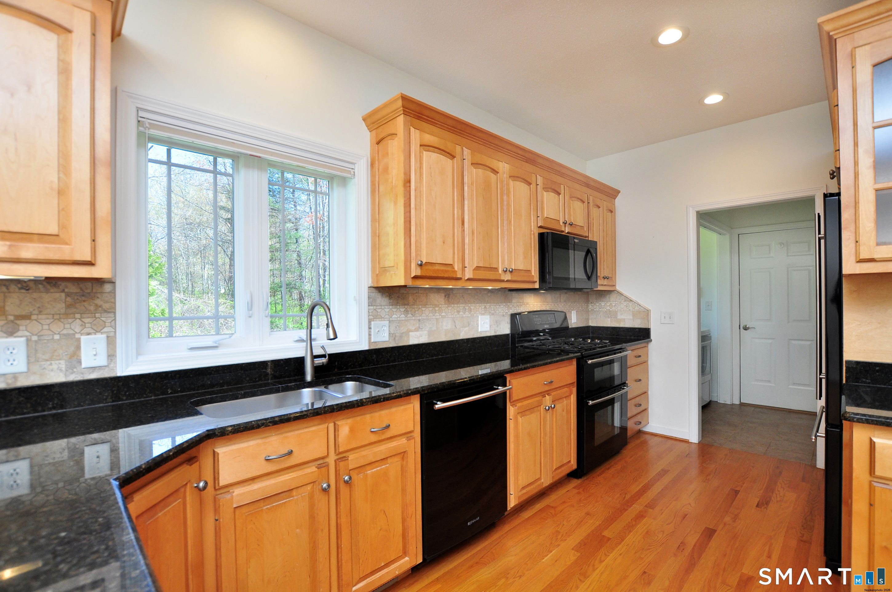 453 Tributary Lane Windsor, CT 06095 - Photo 13 of 37 a kitchen with stainless steel appliances granite countertop a stove a sink and a microwave