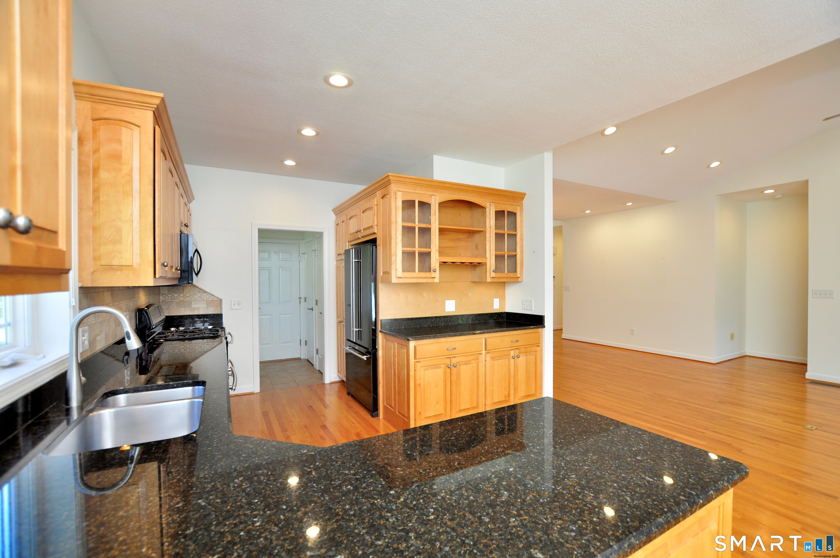 453 Tributary Lane Windsor, CT 06095 - Photo 14 of 37 a kitchen with stainless steel appliances granite countertop a sink and a refrigerator