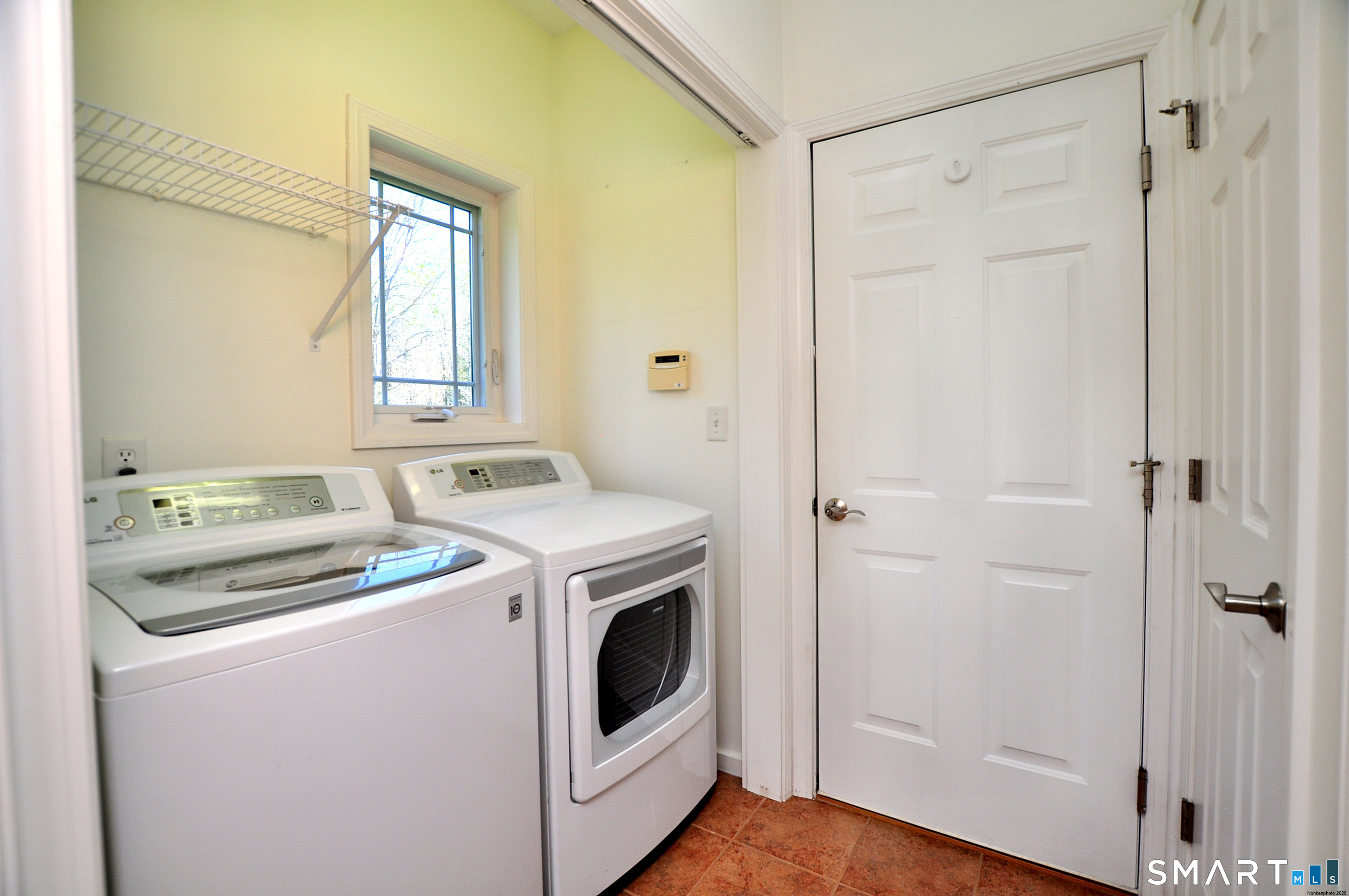 453 Tributary Lane Windsor, CT 06095 - Photo 17 of 37 a view of washer and dryer with wooden floor