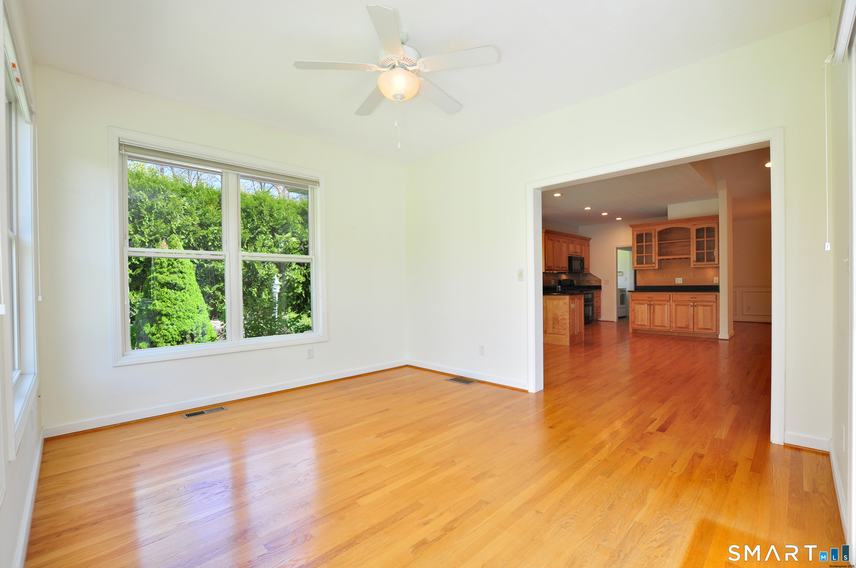 453 Tributary Lane Windsor, CT 06095 - Photo 18 of 37 a view of empty room with wooden floor and fan