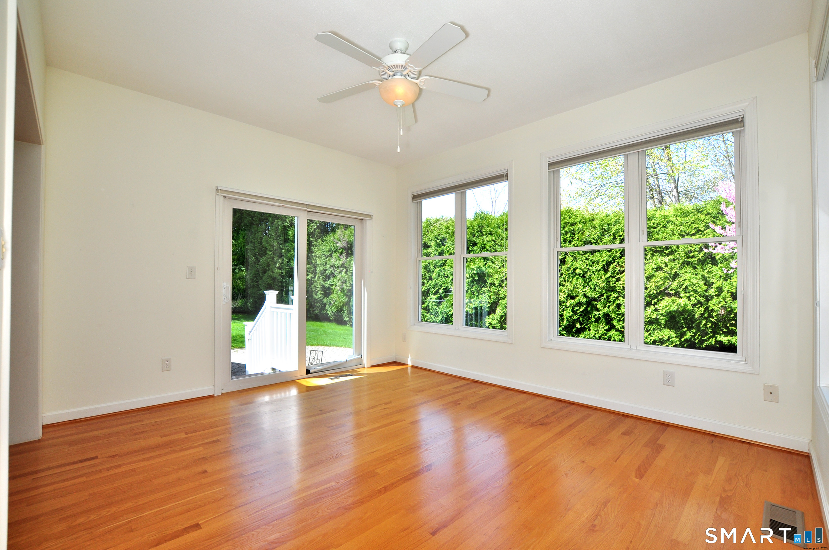 453 Tributary Lane Windsor, CT 06095 - Photo 21 of 37 a view of an empty room with wooden floor and a window