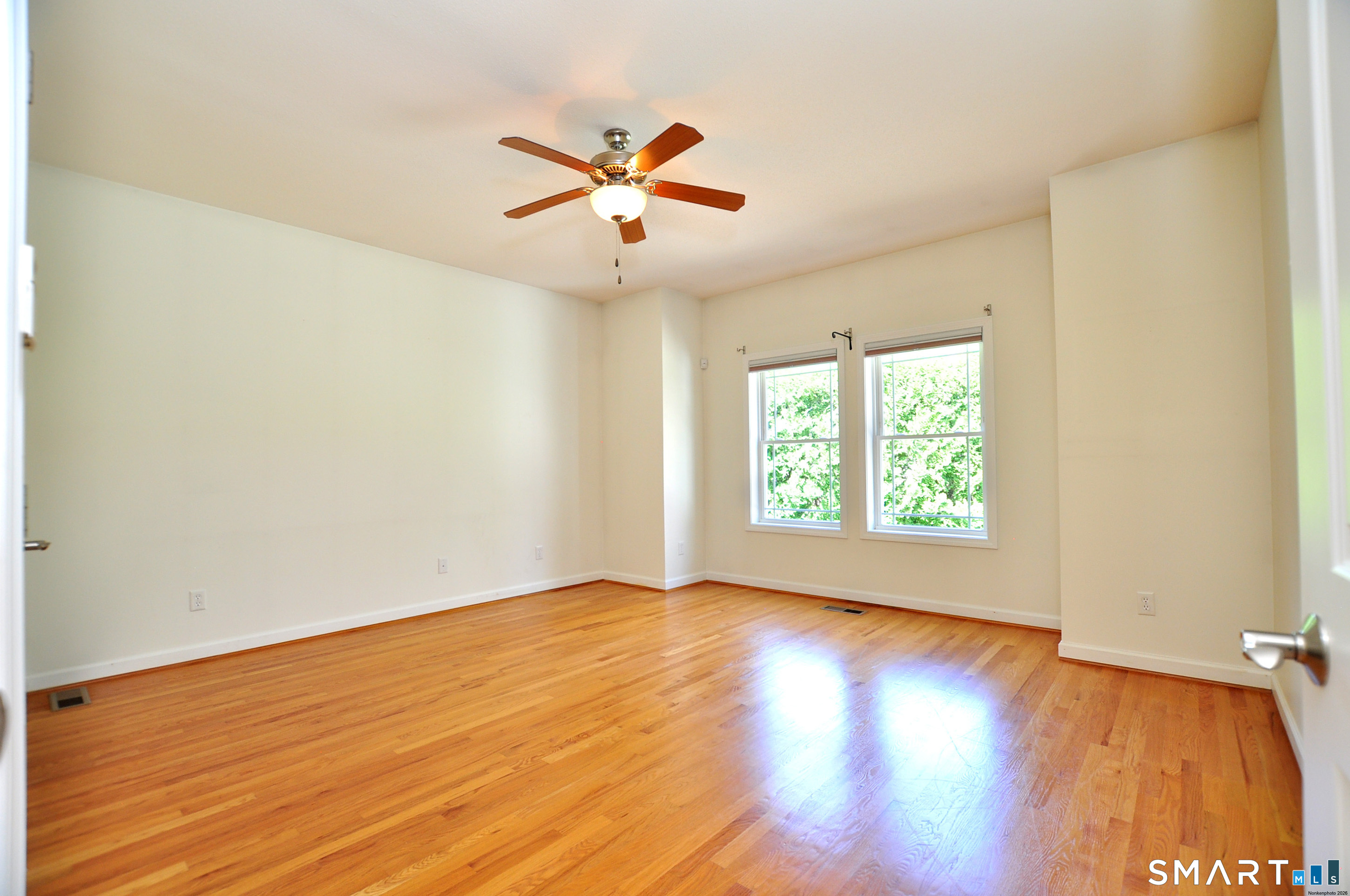 453 Tributary Lane Windsor, CT 06095 - Photo 22 of 37 a view of an empty room with wooden floor and a window