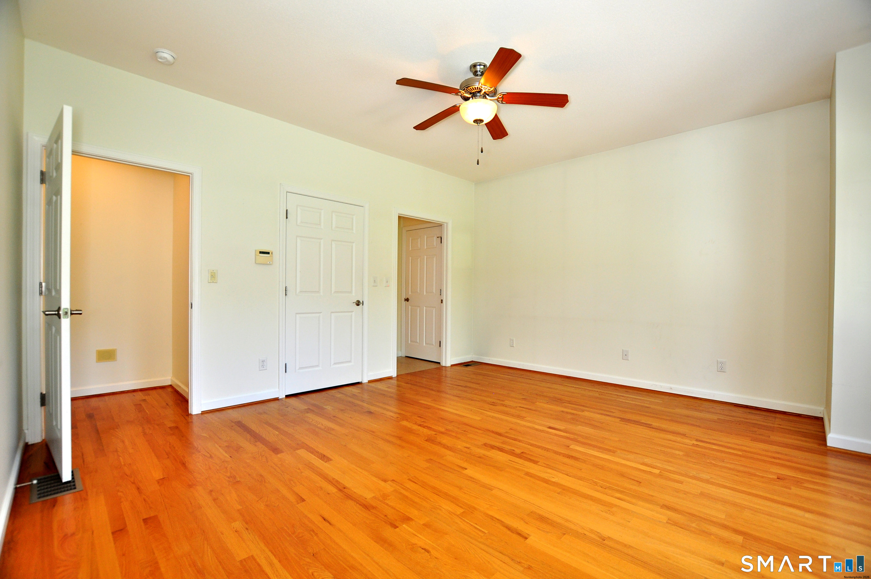 453 Tributary Lane Windsor, CT 06095 - Photo 23 of 37 an empty room with wooden floor and ceiling fan