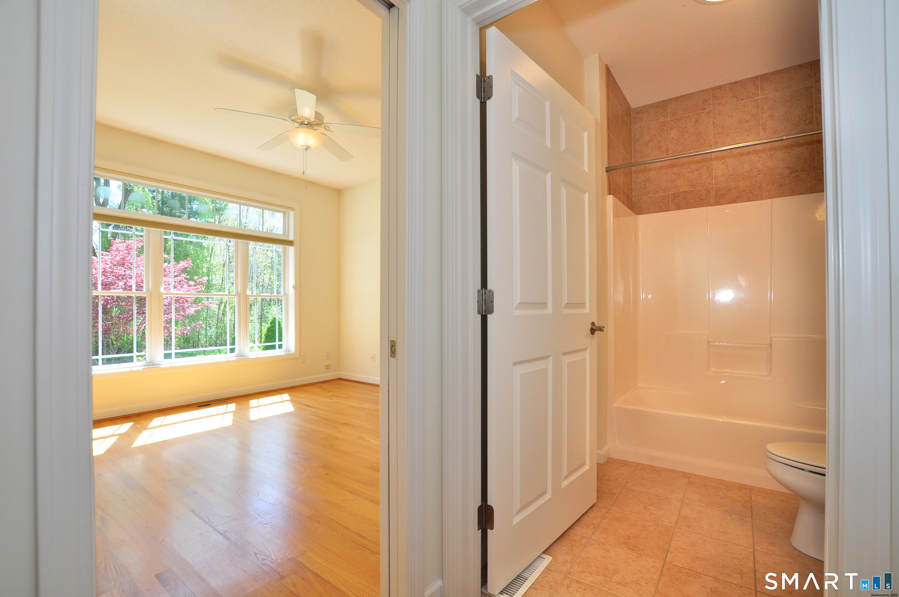 453 Tributary Lane Windsor, CT 06095 - Photo 27 of 37 a empty room with a large window and wooden floor