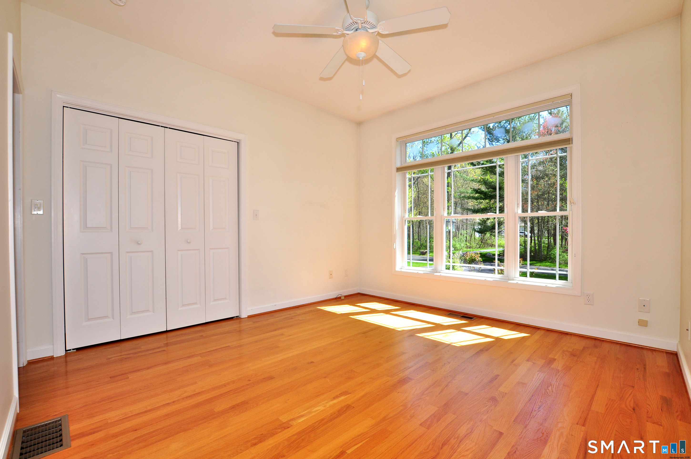 453 Tributary Lane Windsor, CT 06095 - Photo 28 of 37 a view of an empty room with a window and wooden floor