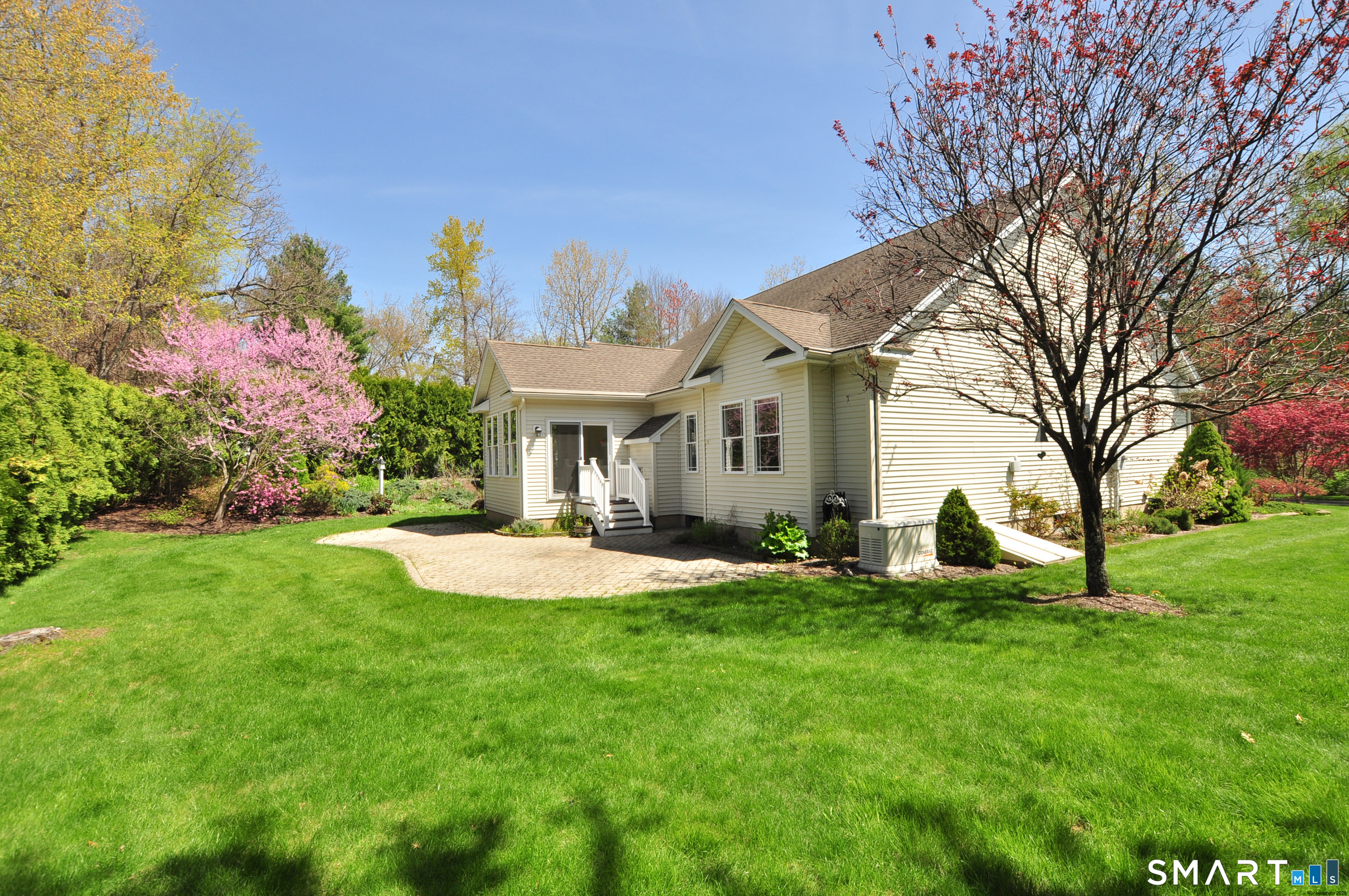 453 Tributary Lane Windsor, CT 06095 - Photo 3 of 37 a front view of a house with a yard and trees